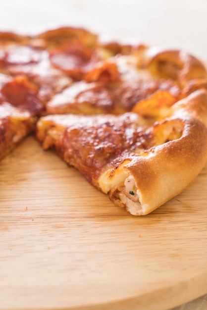 Homemade Pepperoni Pizza on wood plate