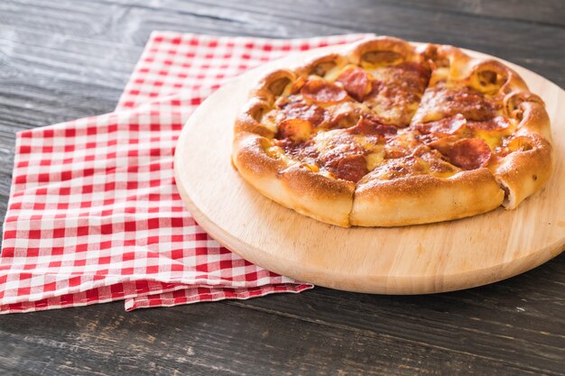 Homemade Pepperoni Pizza on wood plate