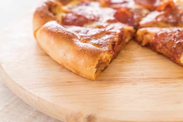 Homemade Pepperoni Pizza on wood plate