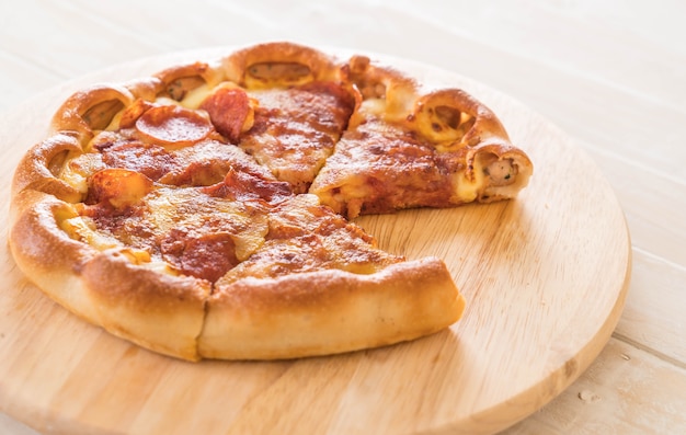 Homemade Pepperoni Pizza on wood plate