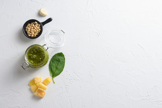 Homemade Pesto alla Genovese in glass jar with ingredients