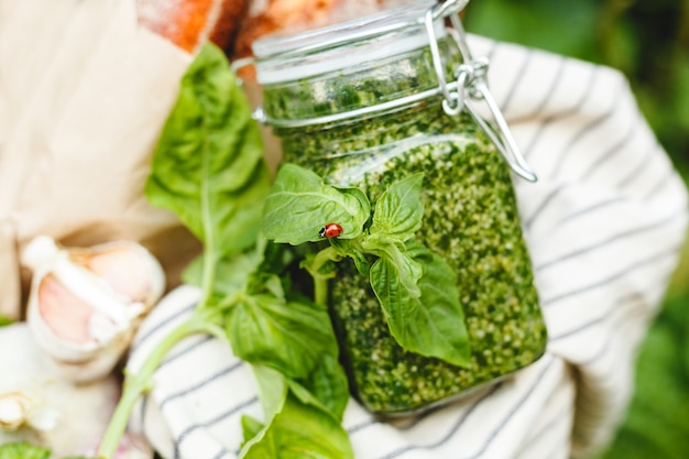 Homemade Pesto in glass jar with basil