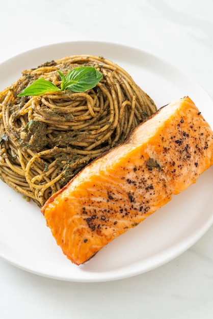 homemade pesto spaghetti pasta with grilled salmon - Italian food style