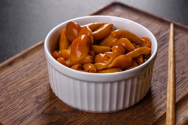 Homemade pickled honey agarics mushrooms in a white bowl