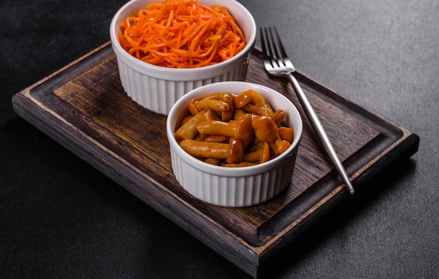 Homemade pickled honey agarics mushrooms in a white bowl