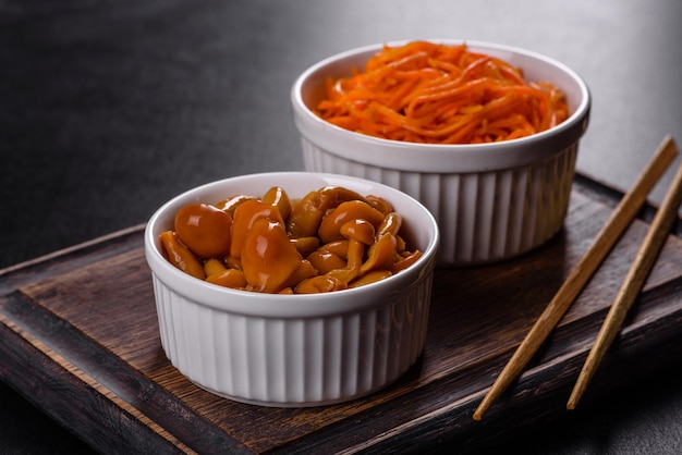 Homemade pickled honey agarics mushrooms in a white bowl