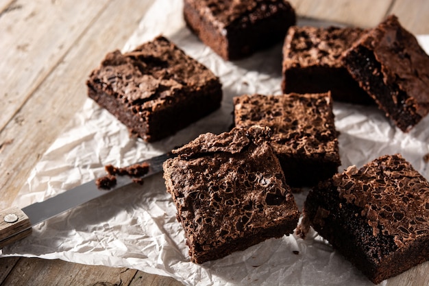 Homemade pieces of brownies on rustic wooden table