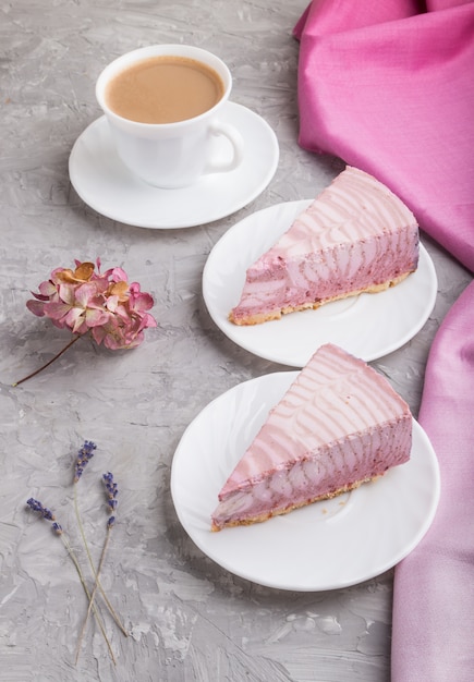 Homemade pink cheesecake with cup of coffee. side view.