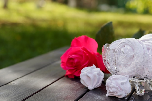 Homemade pink marshmallows, zephyr in glass bowl on wooden background. Place for text.