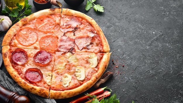 Homemade pizza with bacon salami and tomatoes Top view