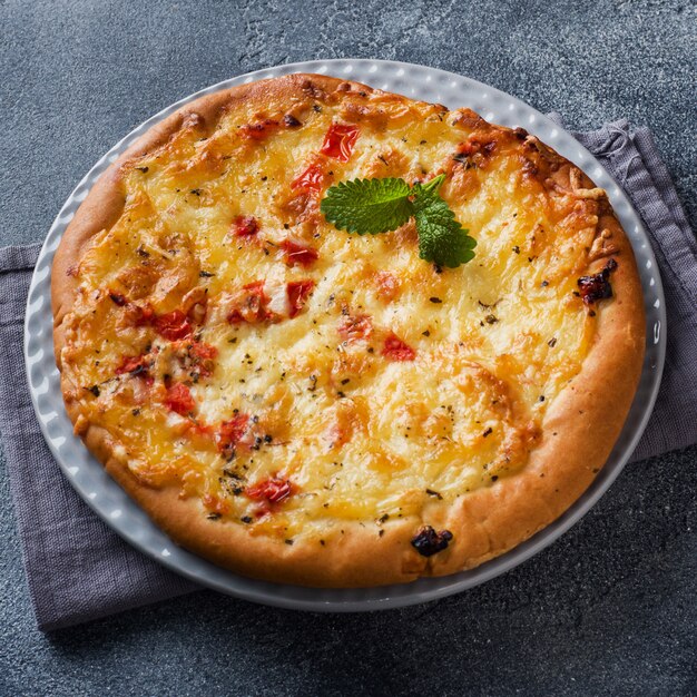 Homemade pizza with cheese and tomato sauce