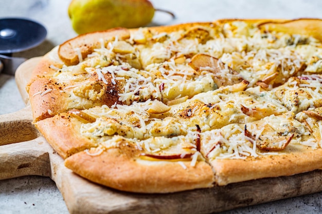 Homemade pizza with pear and gorgonzola gray background