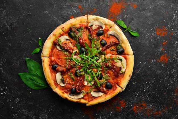 Homemade pizza with sundried tomatoes mushrooms and olives Italian cuisine Food delivery