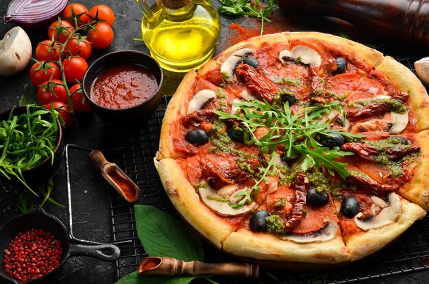 Homemade pizza with sundried tomatoes mushrooms and olives Italian cuisine Food delivery