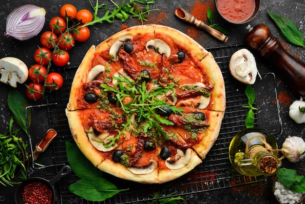 Homemade pizza with sundried tomatoes mushrooms and olives Italian cuisine Food delivery