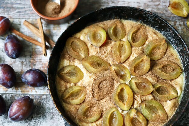 Homemade plum pie. Cooking plum cake. Selective focus. 