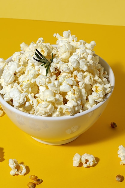 Homemade popcorn on colored table with high contrast light. Snack concept