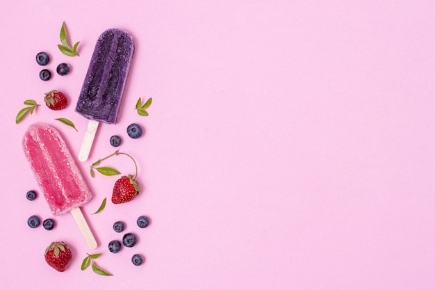 Homemade popsicle ice cream with blueberries and strawberries