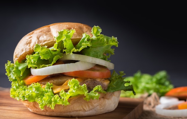 Homemade pork hamburger on black background