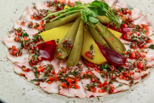 Homemade potato salad with bacon and pickles