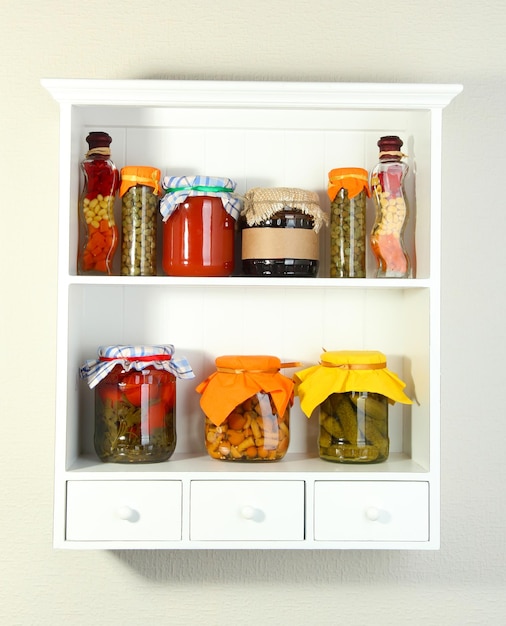 Homemade preserves on beautiful white shelves