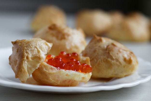 Homemade profiteroles with red caviar with 