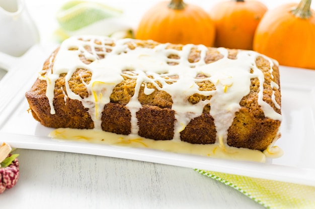 Homemade pumpkin bread with orange glazing on top.