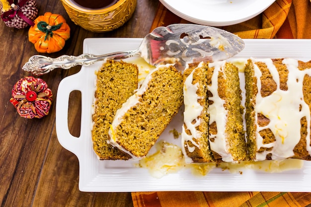 Homemade pumpkin bread with orange glazing on top.