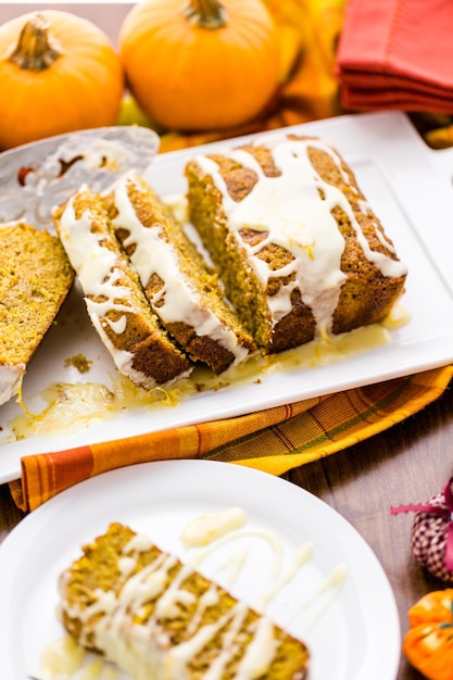 Homemade pumpkin bread with orange glazing on top.