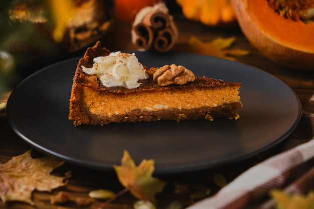 Homemade pumpkin cheesecake decorated with whipped cream.