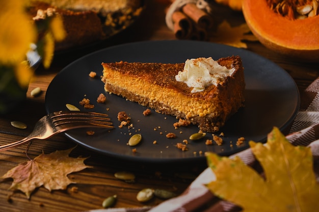 Homemade pumpkin cheesecake decorated with whipped cream.