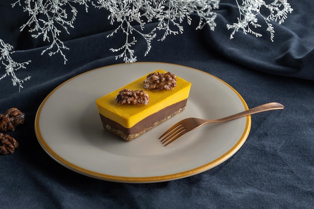 Homemade pumpkin pie with chocolate and nuts Decorated with walnuts Laid on a plate on background