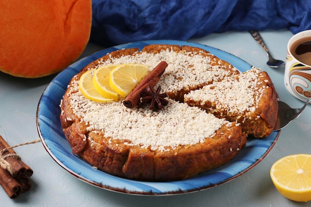 Homemade pumpkin pie with lemon cinnamon and walnuts sprinkled with coconut sliced