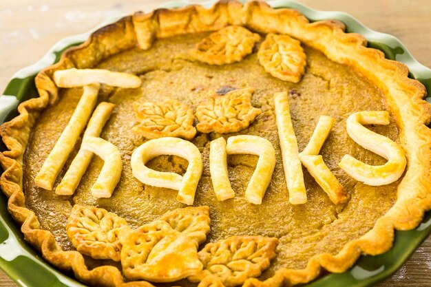 Homemade pumpkin pies with Give Thanks sign and Autumn stamped leafs.