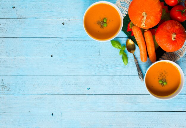 Homemade Pumpkin Soup on rustic wooden table