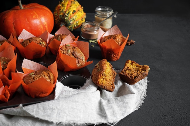 Homemade pumpkin spice muffins with seeds dark background copy space