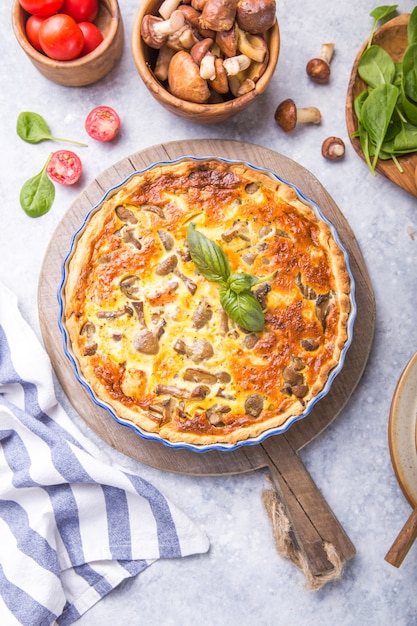 Homemade quiche lorraine with chiken, mushrooms, cheese. top view. Cooking. Spices, butter.  Tart.