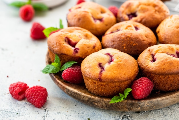 Homemade Raspberry Muffins on Wooden Plate