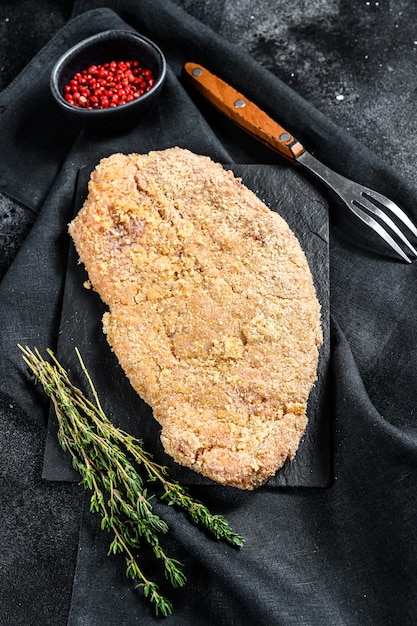 Homemade raw breaded German Weiner Schnitzel