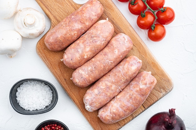 Homemade raw pork sausages, on white table