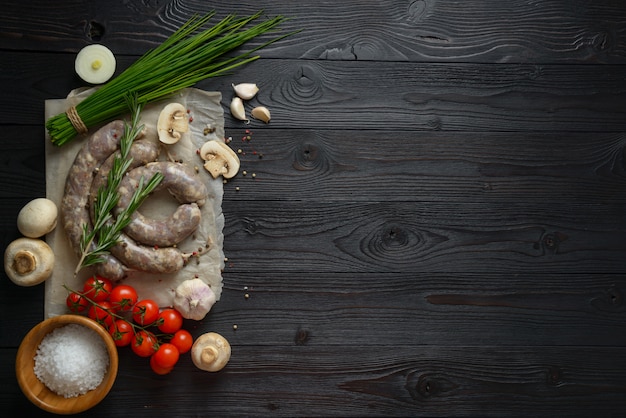 Homemade raw sausages on a wooden surface