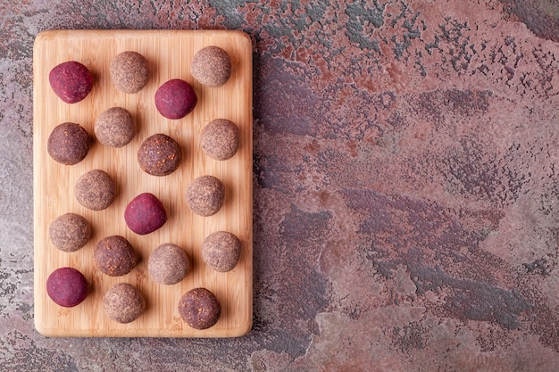 Homemade Raw Vegan Cacao Energy Balls on Wooden Board