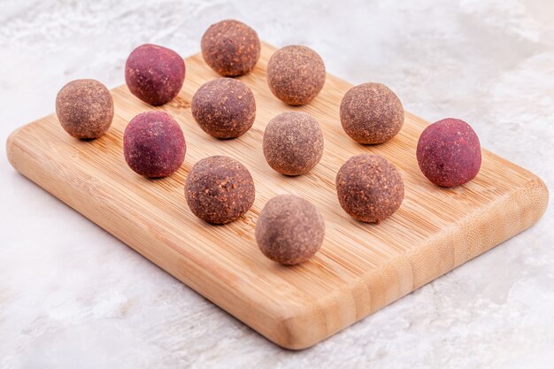 Homemade raw vegan cacao energy balls on wooden tray