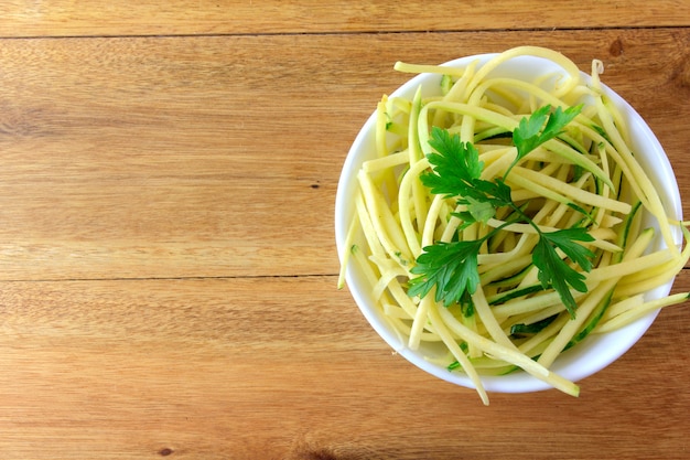 Homemade raw zucchini pasta in ceramic bowl