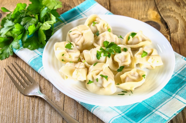 Homemade ready dumplings on an old wooden table.