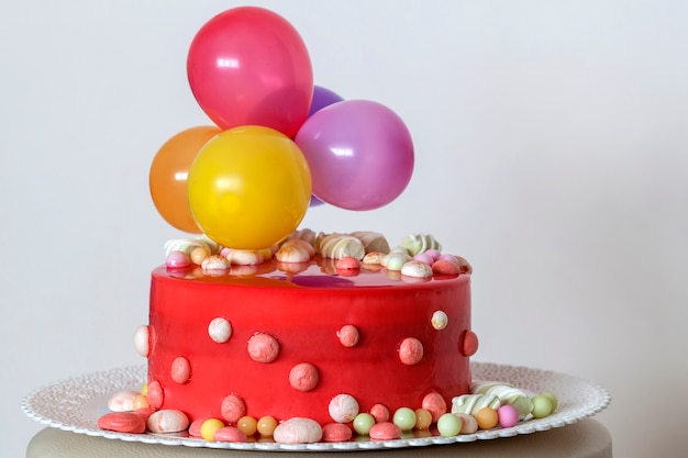 Homemade red birthday cake with air baloons