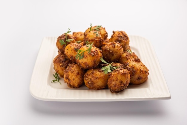 Homemade roasted bombay potatoes pan fried little baby potatoes or aloo with jeera seeds and coriander in bowl