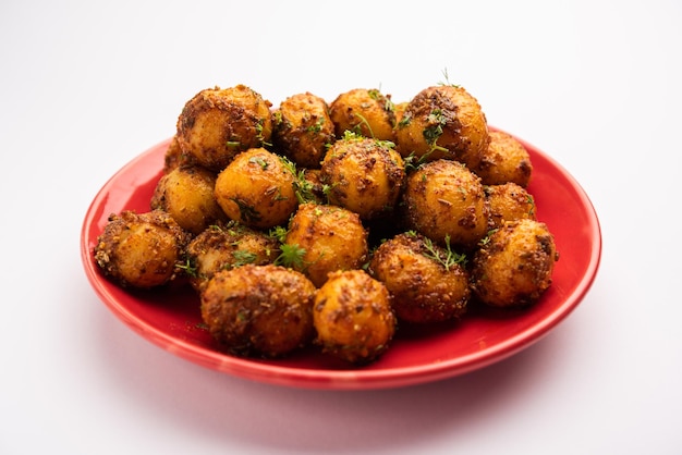 Homemade Roasted Bombay potatoes Pan fried little baby potatoes or aloo with jeera seeds and coriander in bowl