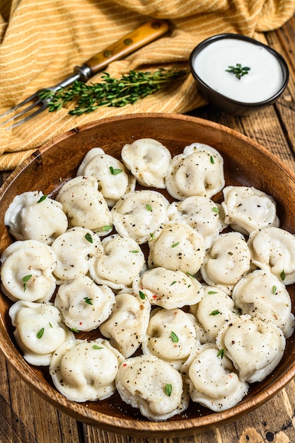 나무 그릇에 쇠고기와 돼지 고기로 만든 러시아 만두 Pelmeni