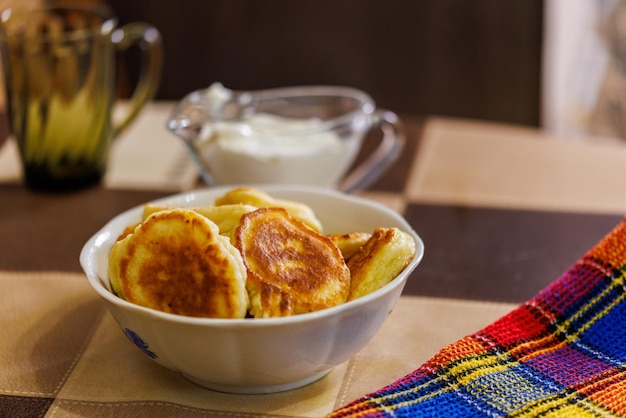 Homemade russian pancakes on ceramic bowl on dinner table